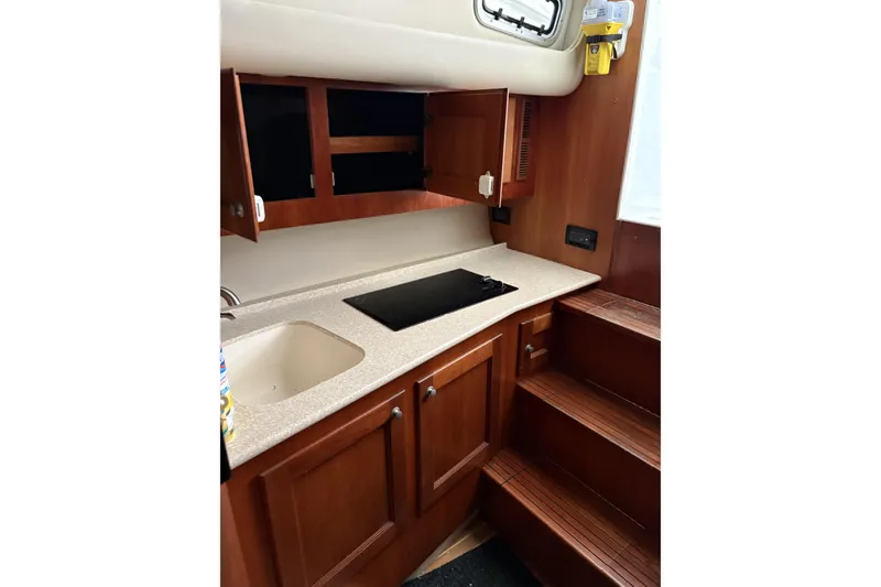 Slide: The Image of 2006 Rampage 38 Express boat interior with rod holders and storage compartments. - 16