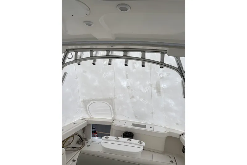 Slide: The Image of 2006 Rampage 38 Express boat interior with rod holders and seating area. - 21