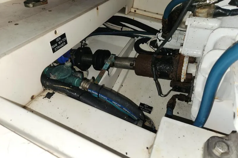 Slide: The Image of Engine compartment of a 2006 Rampage 38 Express boat, showing raw water strainer and hoses. - 28