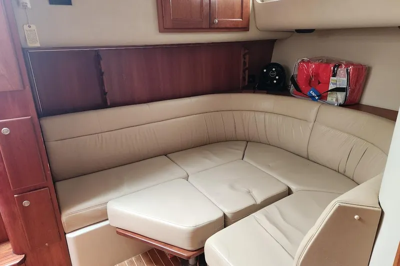 Slide: The Image of 2006 Rampage 38 Express cabin interior with beige leather seating and wooden accents. - 29