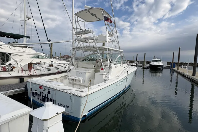 Slide: The Image of 2007 Rampage 38 Express boat docked at marina under cloudy sky. - 33