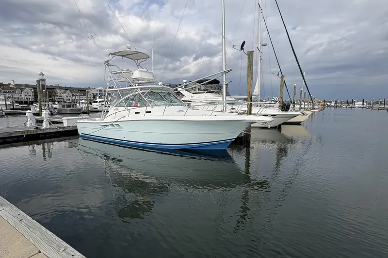Slide: The Image of 2007 Rampage 38 Express yacht docked at a marina under cloudy skies. - 34
