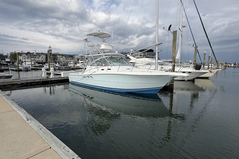 Slide: The Image of 2007 Rampage 38 Express yacht docked in a marina under cloudy skies. - 36