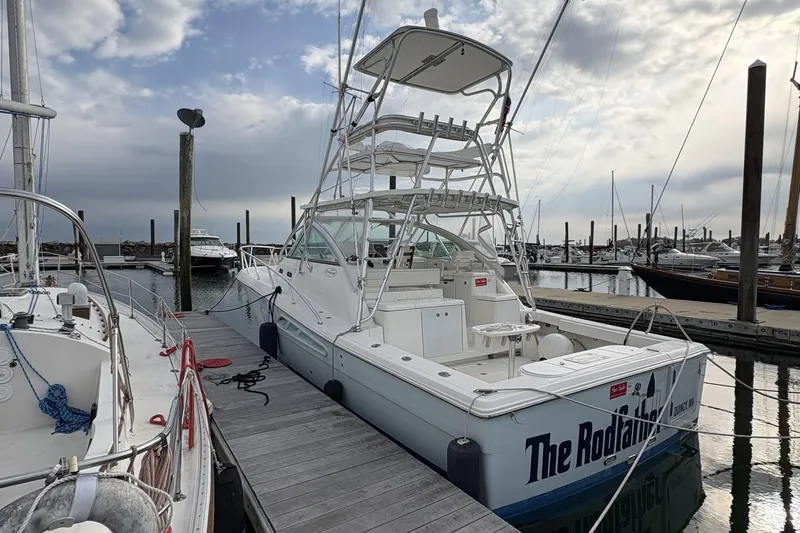 Slide: The Image of 2007 Rampage 38 Express boat docked at marina under cloudy sky. - 37