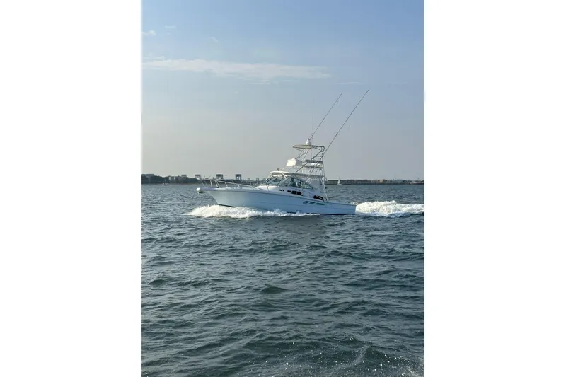 Slide: The Image of 2006 Rampage 38 Express boat cruising on open water. - 4