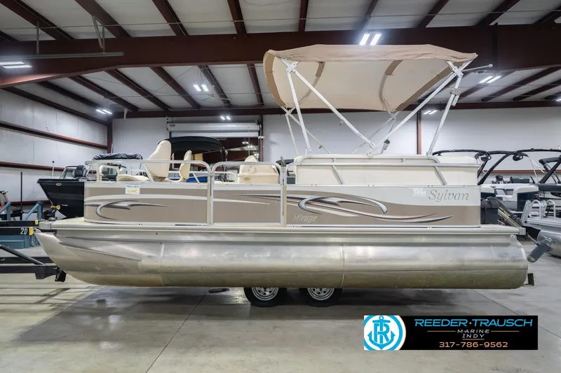 Slide: The Image of 2009 Sylvan 818 Mirage Fish pontoon boat in indoor showroom, side view. - 11