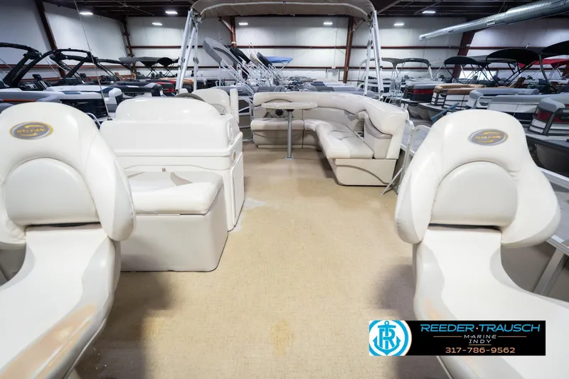 Slide: The Image of 2009 Sylvan 818 Mirage Fish boat interior with white seating in a showroom. - 16