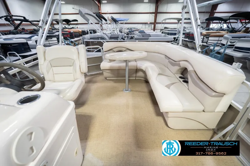 Slide: The Image of 2009 Sylvan 818 Mirage Fish boat interior with beige seating and table in showroom. - 17