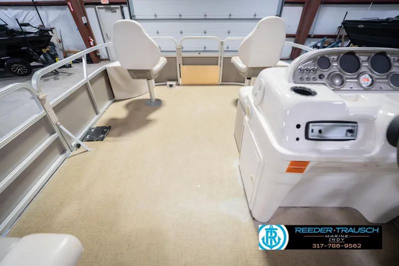 Slide: The Image of 2009 Sylvan 818 Mirage Fish boat interior with helm and seating in a showroom. - 20