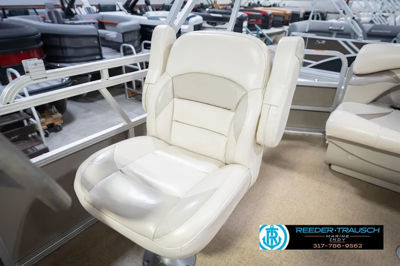 Slide: The Image of White captain's chair on 2009 Sylvan 818 Mirage Fish boat, showroom setting. - 24