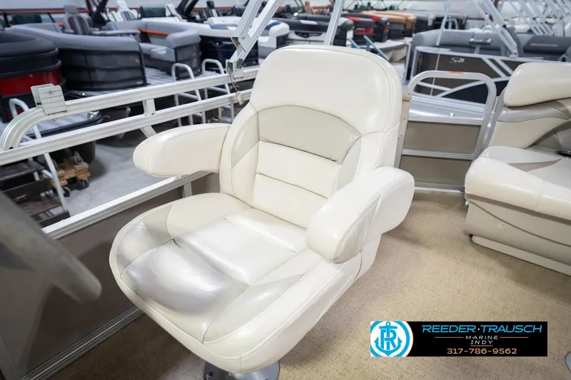 Slide: The Image of White captain's chair on 2009 Sylvan 818 Mirage Fish boat, showroom setting. - 25