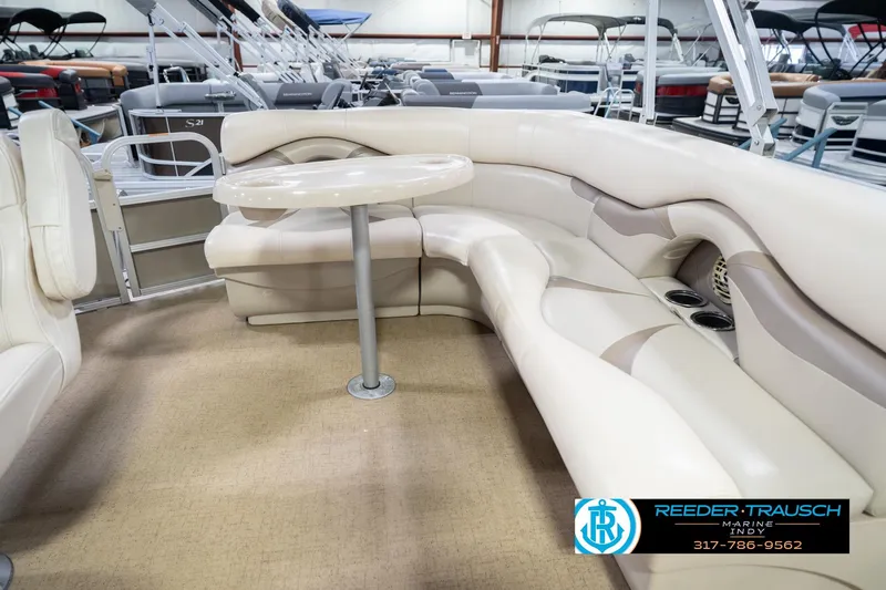 Slide: The Image of 2009 Sylvan 818 Mirage Fish boat interior with beige seating and table. - 26