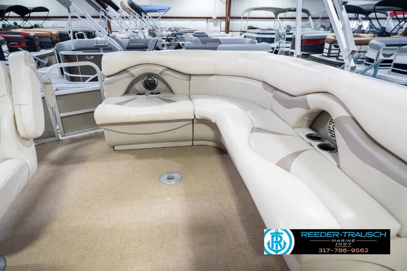 Slide: The Image of 2009 Sylvan 818 Mirage Fish boat interior with beige seating and cup holders. - 27