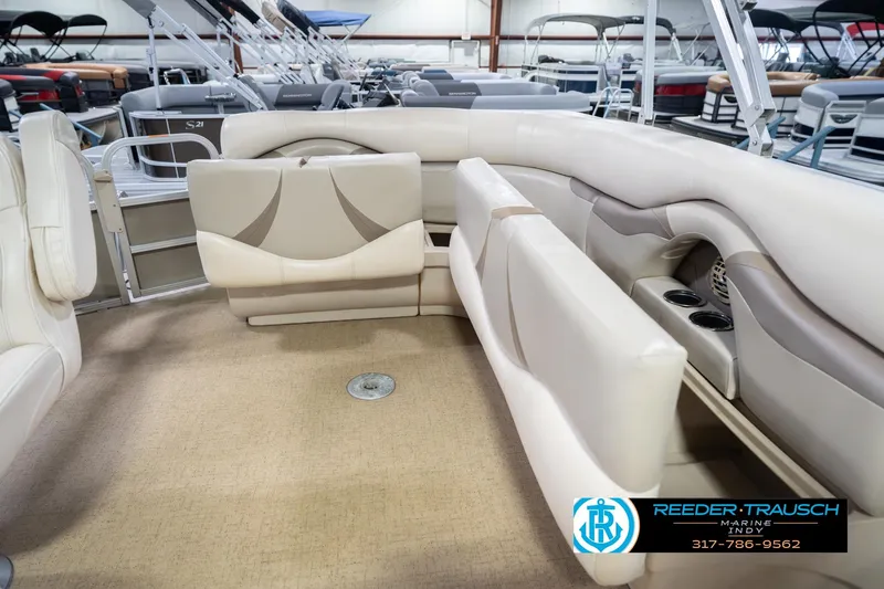 Slide: The Image of 2009 Sylvan 818 Mirage Fish boat interior with beige seating and cup holders. - 28