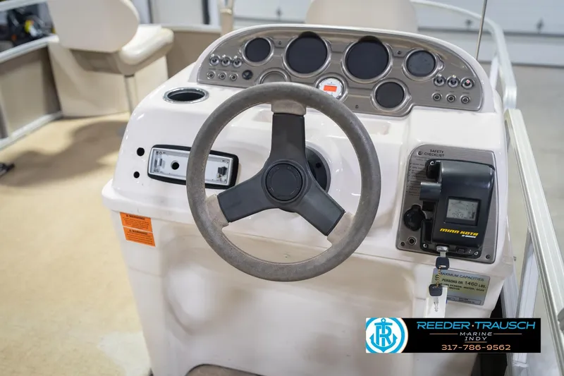 Slide: The Image of 2009 Sylvan 818 Mirage Fish boat dashboard with steering wheel and controls. - 29