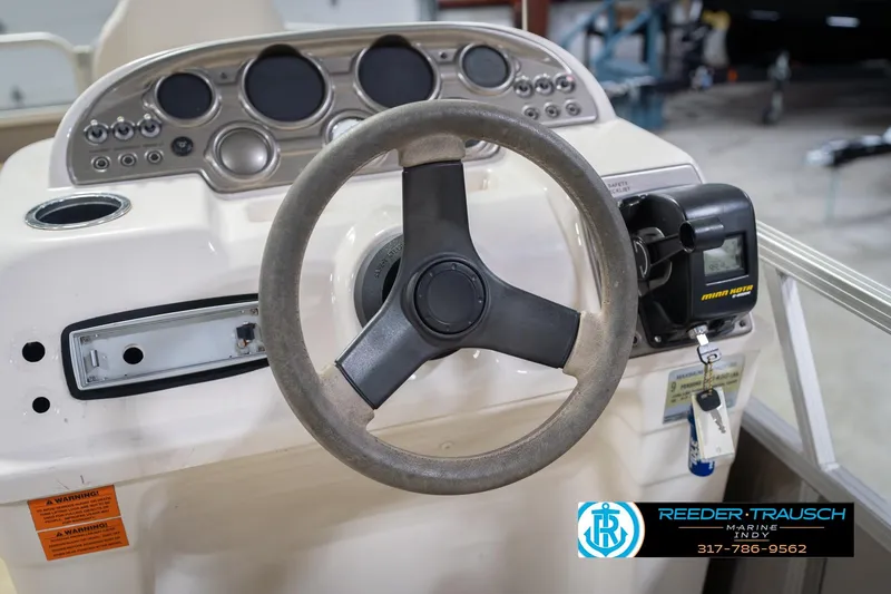 Slide: The Image of Steering console of 2009 Sylvan 818 Mirage Fish boat with control panel and steering wheel. - 30