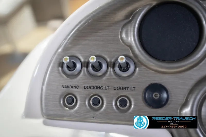 Slide: The Image of Dashboard controls of a 2009 Sylvan 818 Mirage Fish boat with labeled switches. - 32