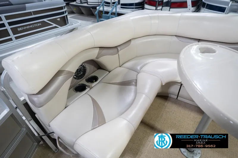 Slide: The Image of 2009 Sylvan 818 Mirage Fish boat interior with beige seating and cup holders. - 39