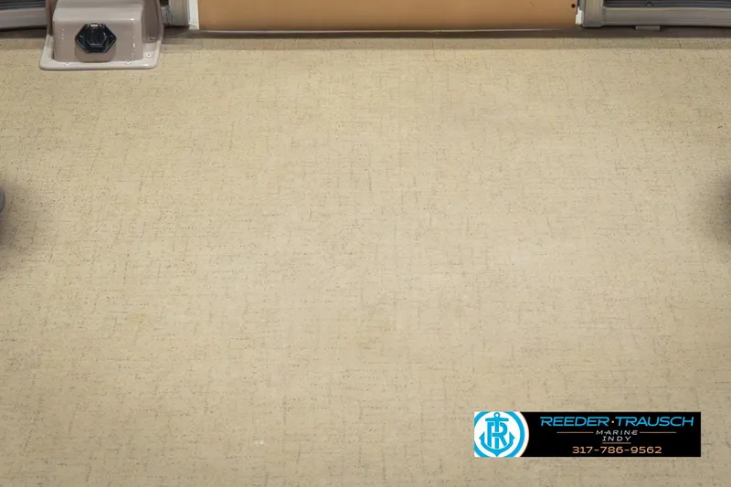 Slide: The Image of 2009 Sylvan 818 Mirage Fish boat interior with beige flooring and Reeder Trausch Marine logo. - 45