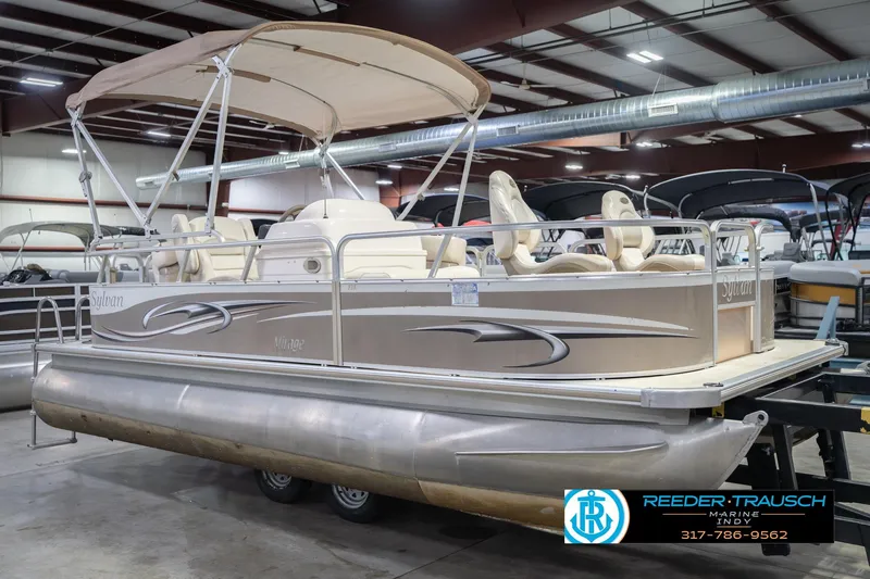 Slide: The Image of 2009 Sylvan 818 Mirage Fish pontoon boat in indoor showroom with canopy. - 6