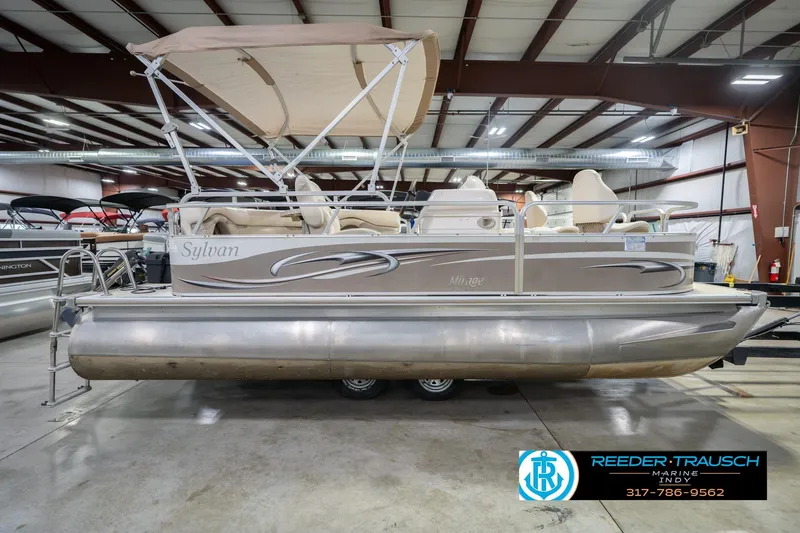 Slide: The Image of 2009 Sylvan 818 Mirage Fish pontoon boat in indoor showroom. - 7