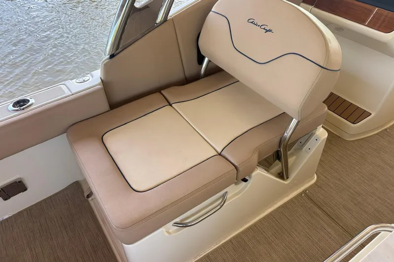 Slide: The Image of 2023 Chris-Craft Calypso 24 boat seat with beige upholstery and elegant design. - 10