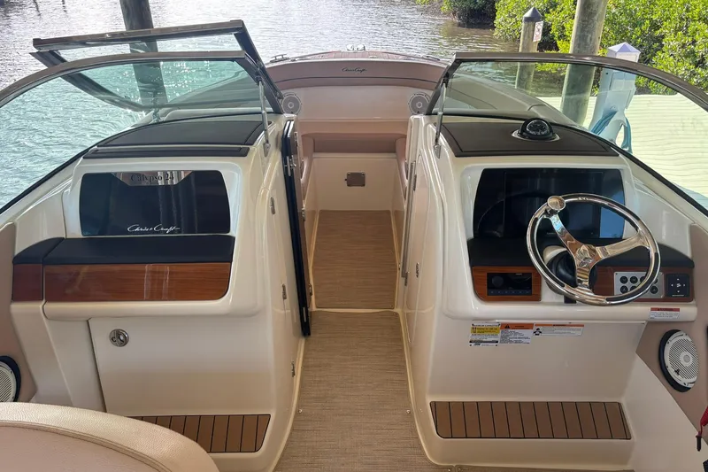 Slide: The Image of 2023 Chris-Craft Calypso 24 boat interior with dual consoles and steering wheel. - 14