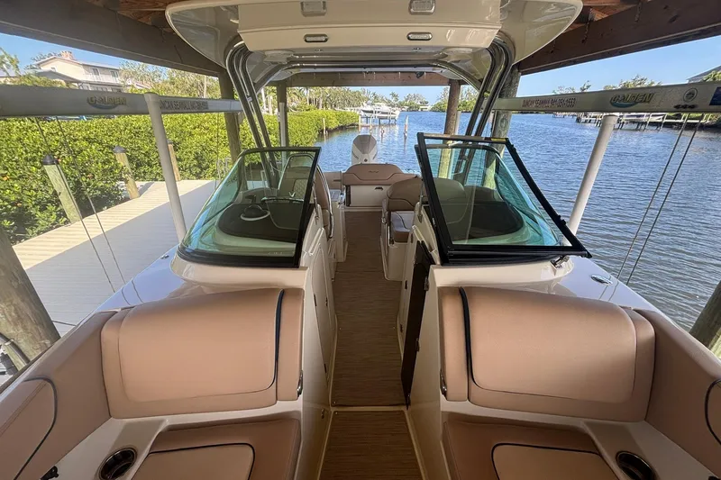 Slide: The Image of 2023 Chris-Craft Calypso 24 boat interior with luxurious seating and waterfront view. - 16