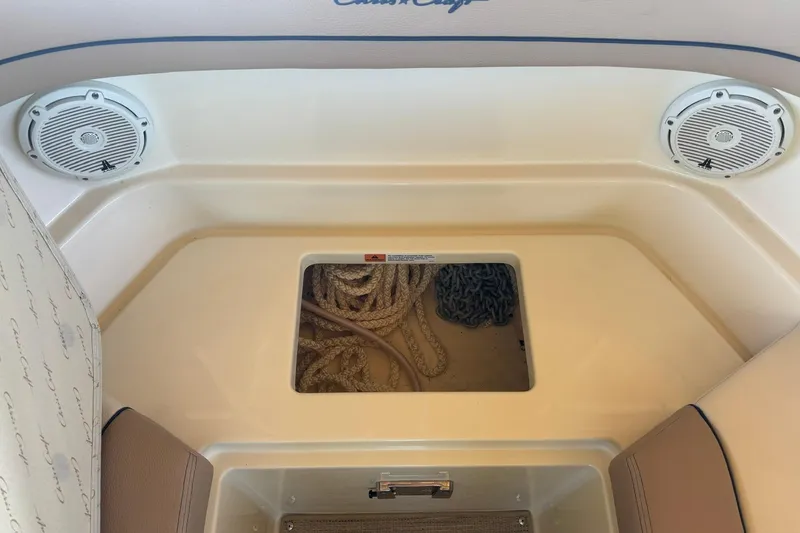 Slide: The Image of 2023 Chris-Craft Calypso 24 boat interior with speakers and storage compartment. - 26