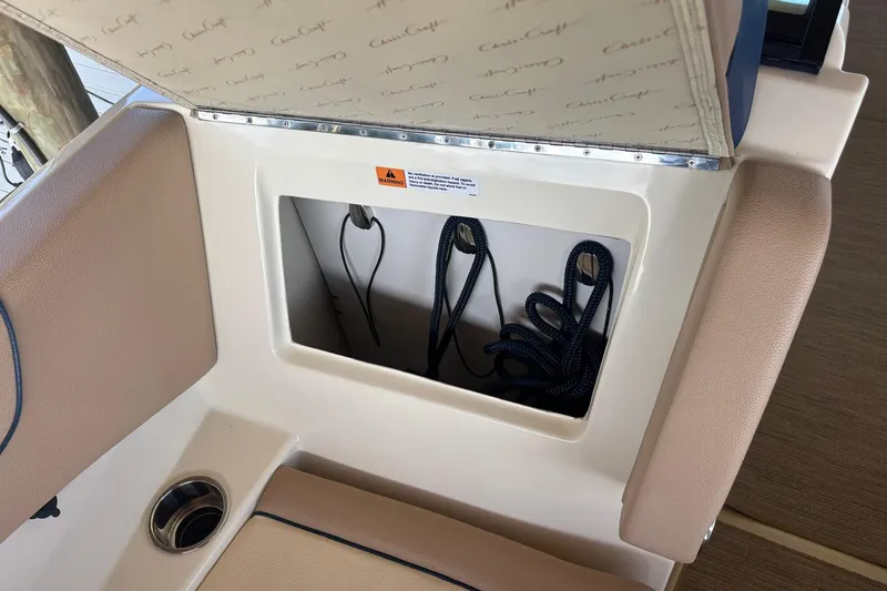 Slide: The Image of 2023 Chris-Craft Calypso 24 storage compartment with ropes and cup holder. - 28