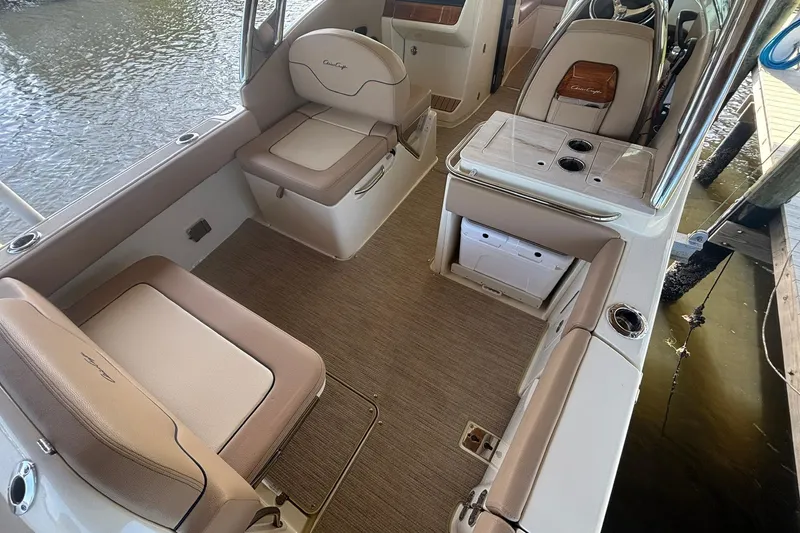 Slide: The Image of 2023 Chris-Craft Calypso 24 boat interior with beige seating and storage compartments. - 6