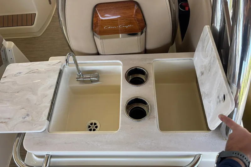 Slide: The Image of 2023 Chris-Craft Calypso 24 boat interior with sink and cup holders. - 7