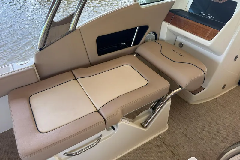 Slide: The Image of 2023 Chris-Craft Calypso 24 interior seating with beige upholstery and elegant design. - 9