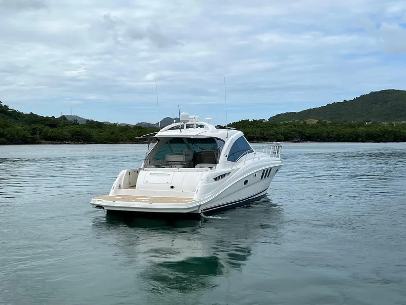 Slide: The Image of 2006 Sea Ray 48 Sundancer anchored on calm waters. - 10