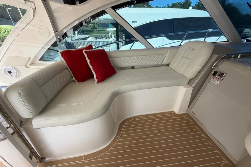 Slide: The Image of Luxurious seating area on a 2006 Sea Ray 48 Sundancer yacht with red accent pillows. - 32