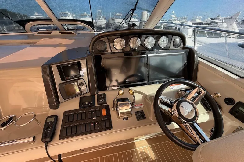 Slide: The Image of Helm of 2006 Sea Ray 48 Sundancer with modern navigation controls and steering wheel. - 35