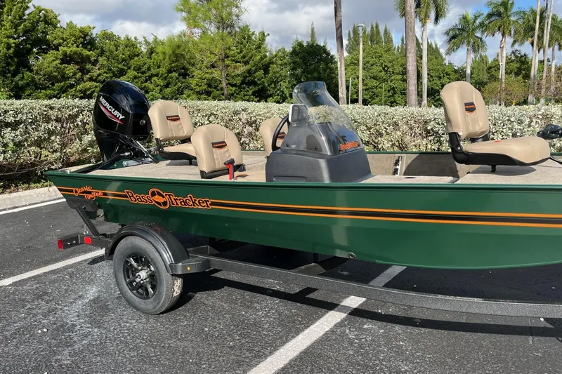 Slide: The Image of 2026 Tracker Bass Tracker Classic Limited boat in parking lot, green with tan seats. - 50
