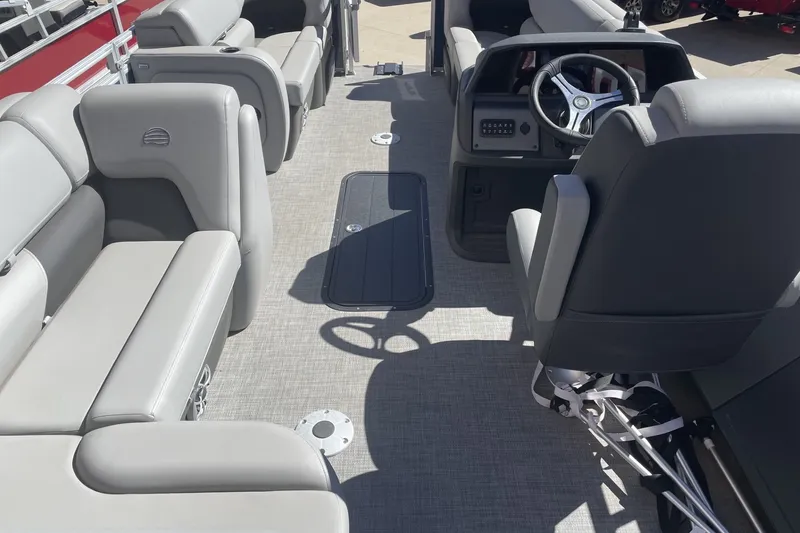 Slide: The Image of Interior of 2026 Sun Tracker SportFish 22 XP3 pontoon boat with plush seating and steering console. - 88