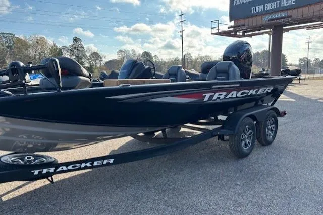 The Image of 2026 Tracker Pro Team 195 boat on trailer, parked outdoors under a clear sky. - 0