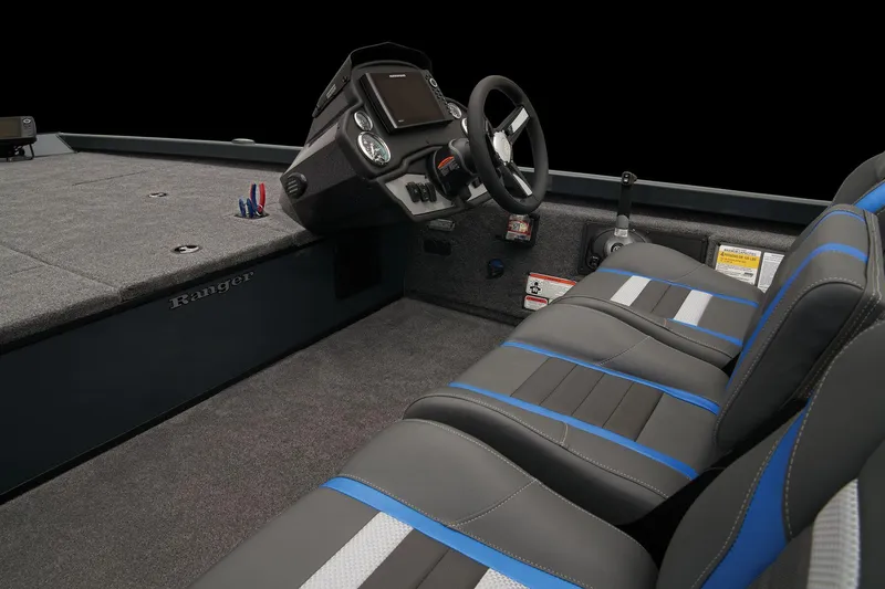 Slide: The Image of Open storage compartment in 2026 Ranger RT188 boat, featuring carpeted interior and red trim. - 43
