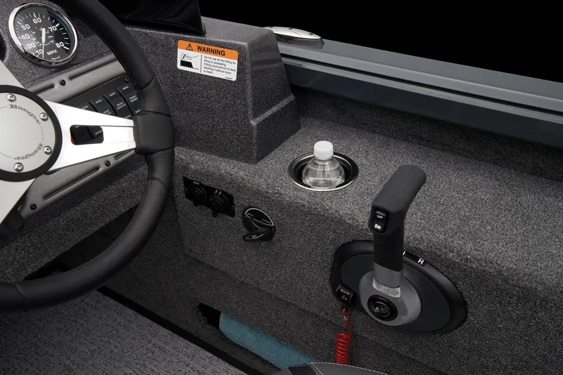 Slide: The Image of Foot pedal control in 2026 Ranger VS1882SC Reata boat, on carpeted floor with cables. - 35