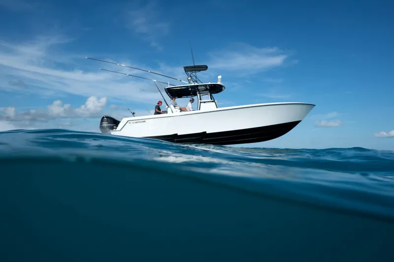 Slide: The Image of 2026 Contender 35 ST boat cruising on open ocean under clear blue sky. - 10