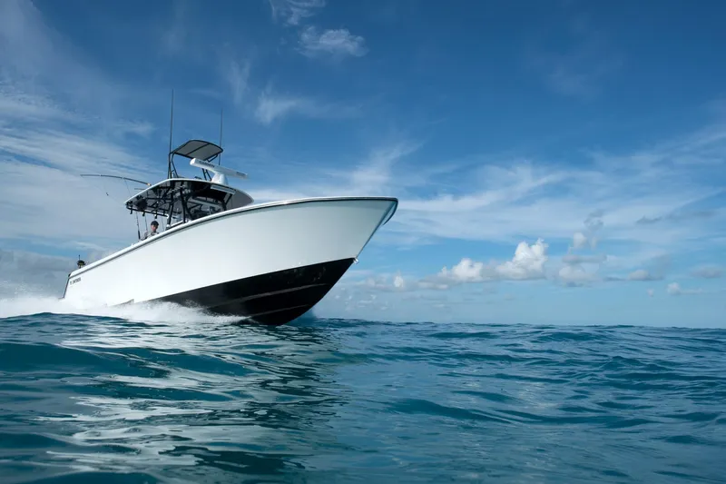 Slide: The Image of 2026 Contender 35 ST boat cruising on open ocean under clear blue sky. - 11