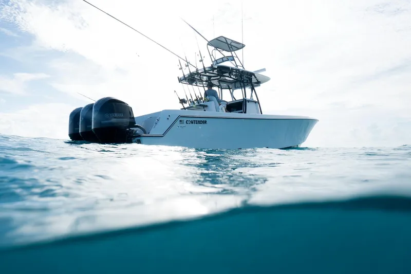 Slide: The Image of 2026 Contender 35 ST boat on ocean with Yamaha engines, under clear sky. - 12