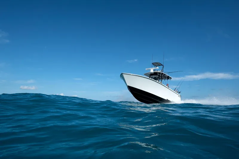 Slide: The Image of 2026 Contender 35 ST boat cruising on open ocean under clear blue sky. - 9