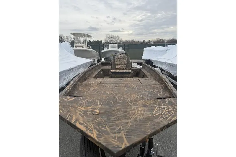 Slide: The Image of 2026 G3 Gator Tough 17 CC boat with camouflage design, parked outdoors. - 4
