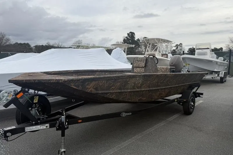 Slide: The Image of 2026 G3 Gator Tough 17 CC boat on trailer, camo design, parked outdoors. - 7