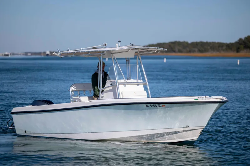 The Image of 2006 Edgewater 228CC boat cruising on calm blue waters. - 0