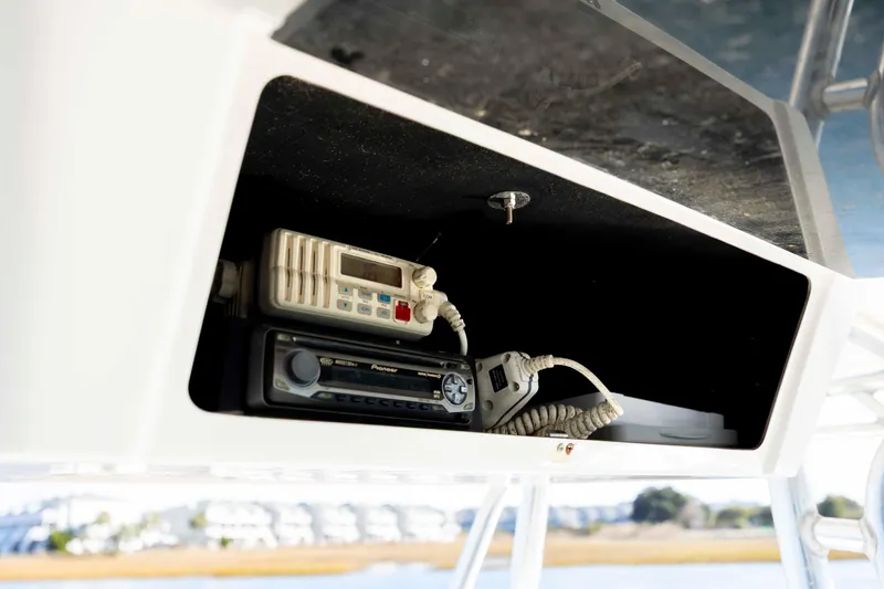 Slide: The Image of 2006 Edgewater 228CC boat radio and communication equipment in storage compartment. - 16