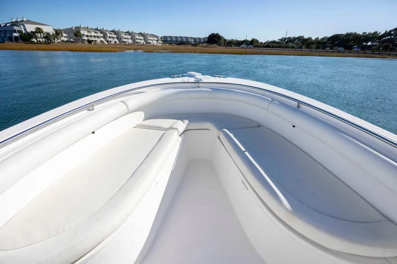 Slide: The Image of Bow view of 2006 Edgewater 228CC boat on calm water near shoreline. - 19